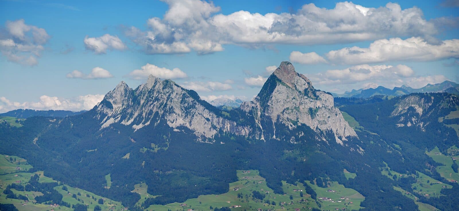 The twin peaks of the Grosser and Kleiner Mythen above green valleys