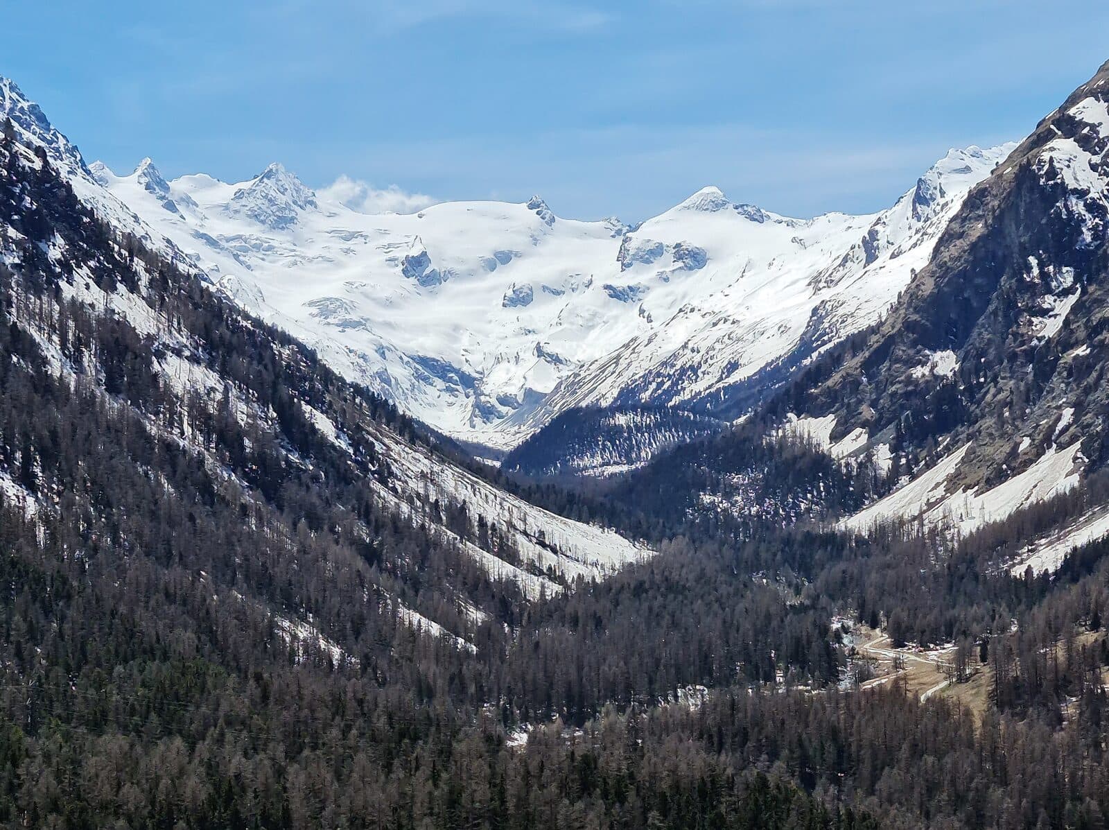 Val Roseg seen from Pontresina, with glaciated peaks at the head of the valley